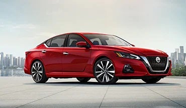 2023 Nissan Altima in red with city in background illustrating last year's 2022 model in Ted Russell Nissan in Knoxville TN