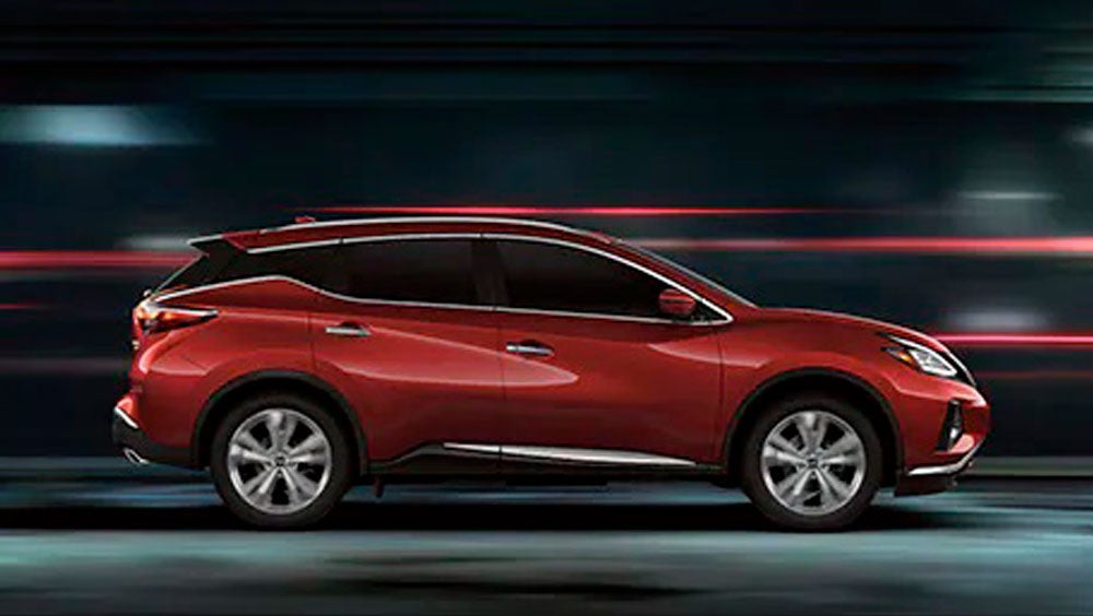 2023 Nissan Murano shown in profile driving down a street at night illustrating performance. | Ted Russell Nissan in Knoxville TN